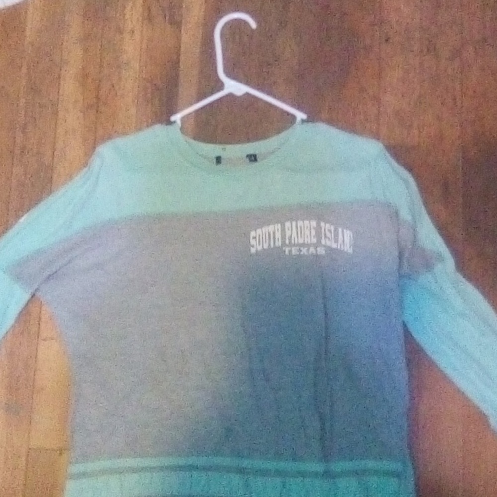 Small, teal and grey long sleeve shirt, says" South Padre island Texas
